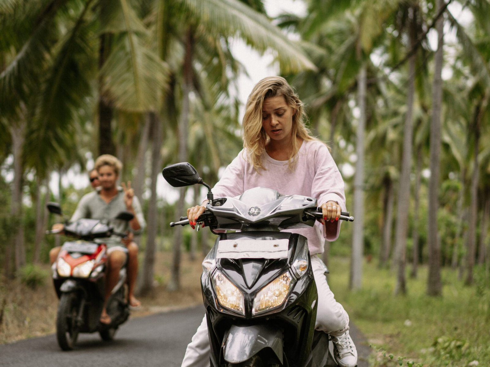 young-woman-driving-moped-tropical-life